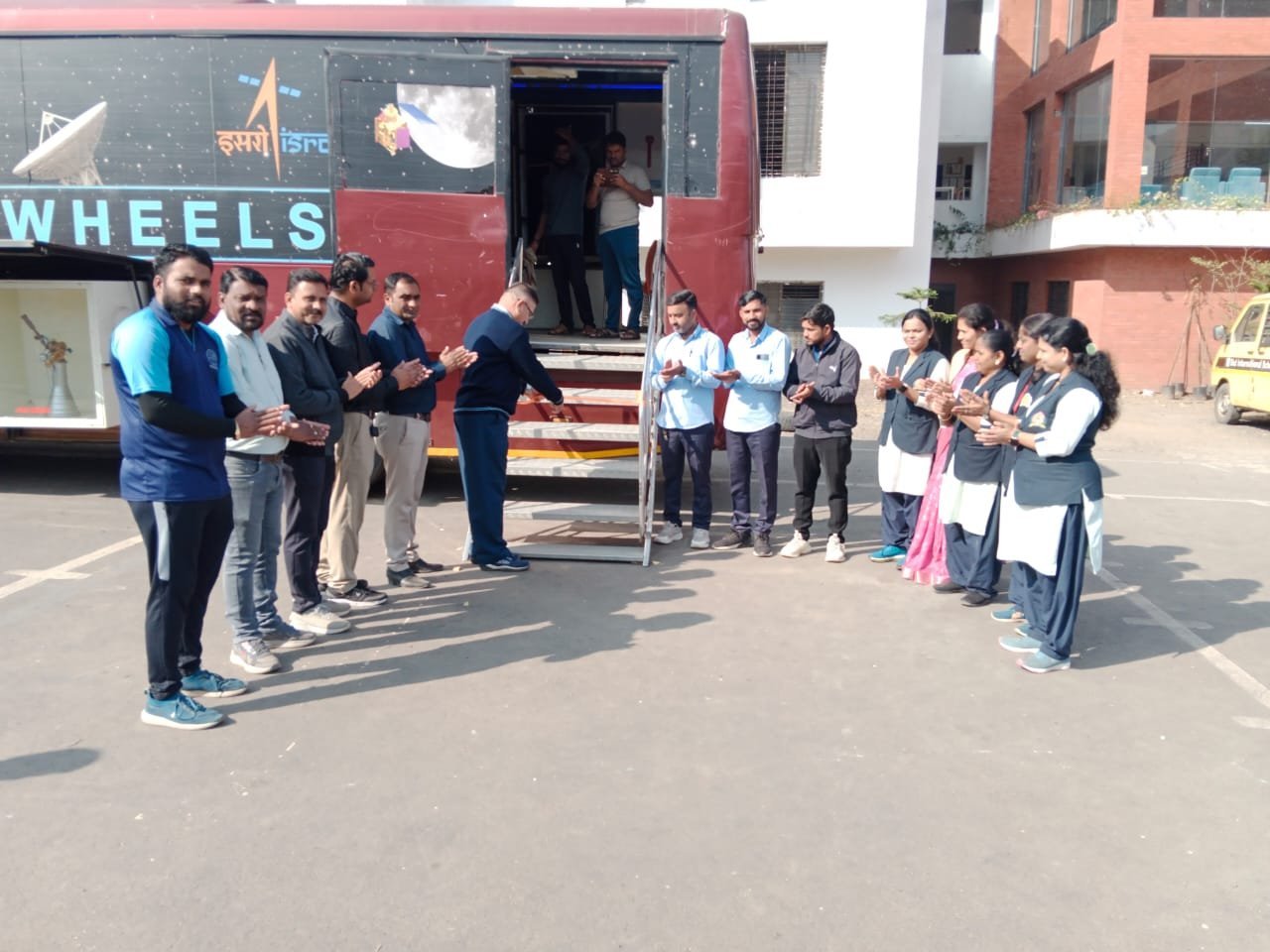 Staff welcoming visitors at the Space On Wheels programme